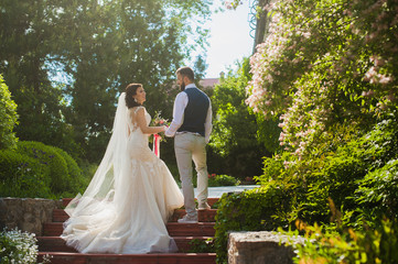 Beautiful happy just married couple in backlight