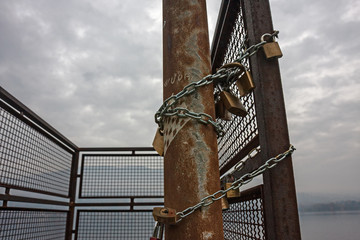 The padlocks of love, chained to the railing by the lake.