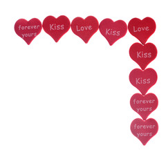 Red hearts confetti on white background with words love kiss