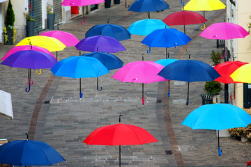 Fototapeta na wymiar Umbrellas hanging in the city, Umbrellas that fly