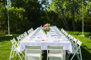 White and long art wedding table outdoors