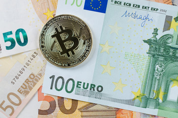 Golden Bitcoin on Euro banknotes.