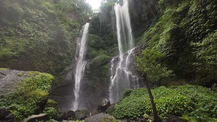 Waterfall in green rainforest. Triple waterfall Sekumpul in the mountain jungle. Bali,Indonesia. Travel concept.