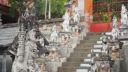 Buddhist temple Brahma Vihara Arama with statues of the gods on Bali island, Indonesia. Balinese...