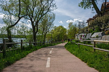 Some cyclists ride the bike path on a sunny spring day