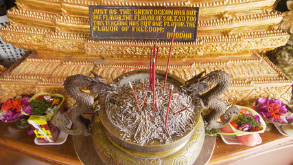 Burning incense sticks in a Buddhist temple on the island of Bali. Incense smoke motion on buddhist temple religion