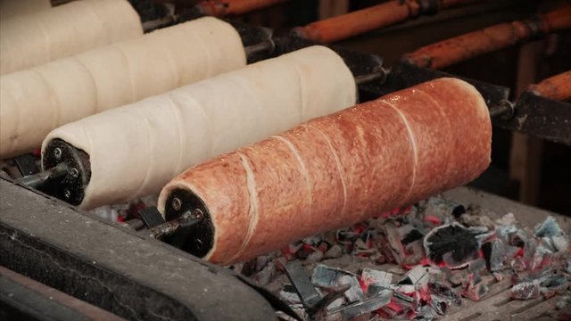 Traditional Hungarian/Czech/Slovakia chimney cake and sweet pastry. Preparation of traditional sweet dough on a street market.