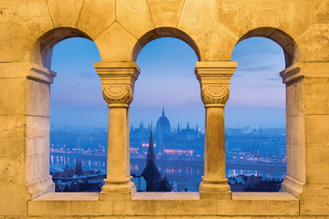 Fototapeta premium Parliament outline view through stone arches of Fishermen's Bastion