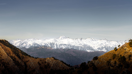 Fototapeta na wymiar Snow clad beautiful white Mountain Pir Panjal range of Himalayas visible from Mata Vaishno Devi, Katra in Jammu and Kashmir of India