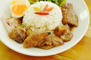 braised pork trotters and boiled egg with rice on plate