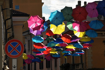 Umbrellas hanging in the city,
Umbrellas that fly
