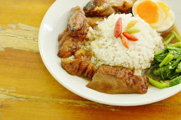 braised pork trotters and boiled egg with rice on plate