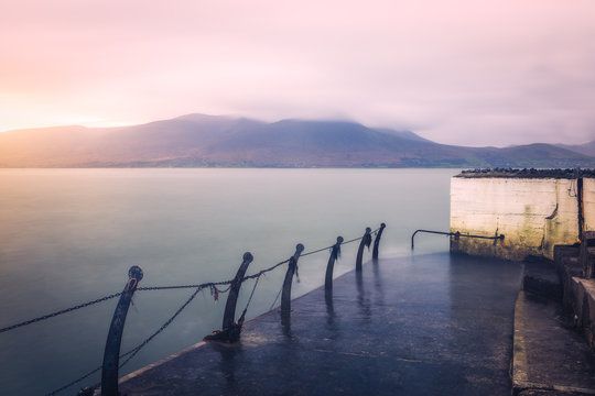 Fenit pier during sunrise. Long exposure seascape.