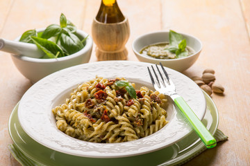 pasta with pesto pistachio and dried tomato,selective focus