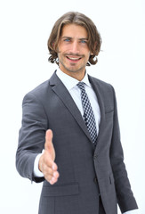 Smiling friendly businessman offers a handshake