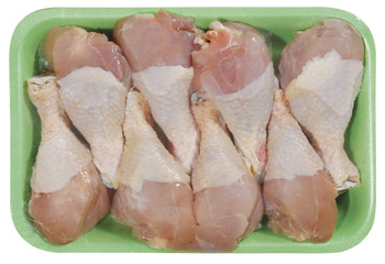 raw chicken meat in plastic tray isolated on white background