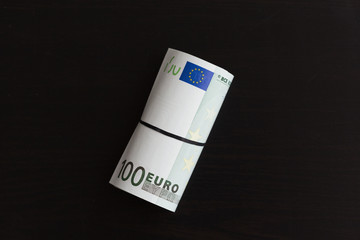 Roll of one hundred euro bills. Shallow dof