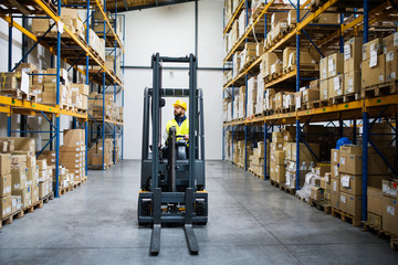 Warehouse man worker with forklift.