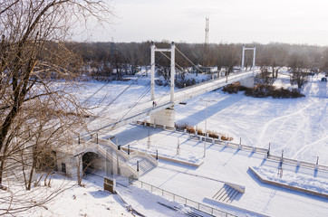 Embankment and pedestrian bridge across the Ural River in Orenburg / Photo taken in Russia, in the winter 01/10/2018