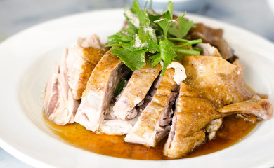 cutting of boiled roast duck meat in dish