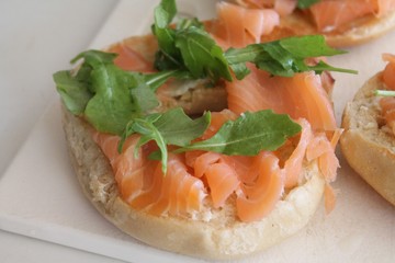 Bagel with smoked salmon and arugula.