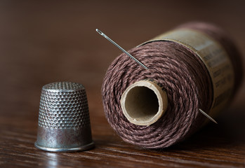Closeup of Thimble and Needle and Thread
