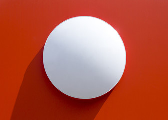 Circle empty signboard isolated on red background.