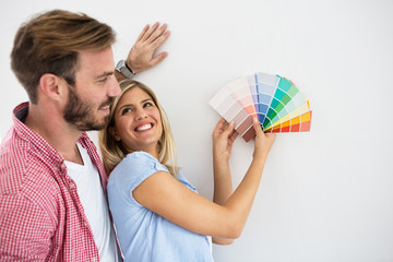 Young happy couple choosing colors