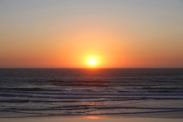 Fototapeta premium Coast of the sea at colorful sunset. Yellow Sun Set in The Middle of The Ocean