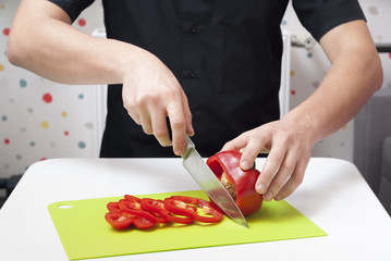man cuts the paprika