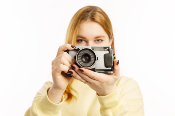 Young woman with an old camera smiling