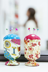 Naklejka premium set of colorful pincushion with pinheads stick on it next to a retail shop counter