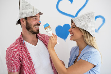 Happy young couple relaxing after painting their home