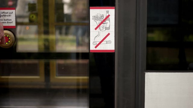 Passenger push the button on a tram doors and getting in through opened doors