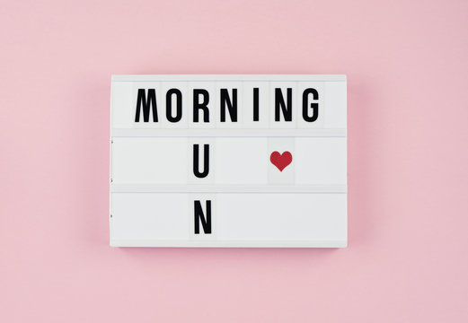 Minimalistic concept of healthy lifestyles and physical activity. Motivation quotes on light box on the pink background