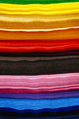 Fototapeta premium pattern of colorful pieces of clothes sorted by color