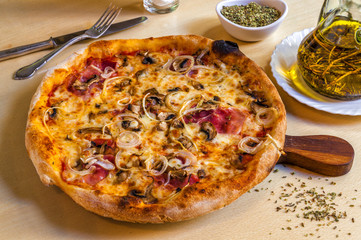 Hot pizza with parma ham, onions and mozarella cheese.
