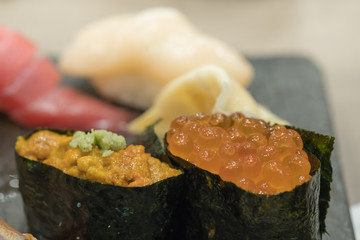 Japanese Traditional food. Close up of ikura (salmon roe) sushi and uni (sea urchin) sushi.