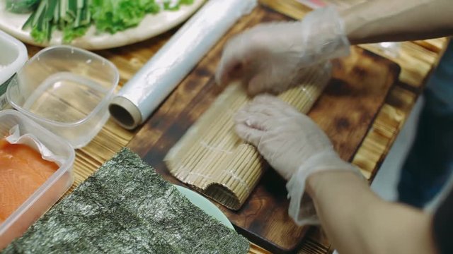 Preparing and cutting traditional sushi