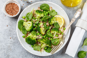Quinoa with broccoli, spinach, peas, lemon and flax  seeds with olive oil. Detox warm or cold salad from green vegetables. Healthy meals, diet. Selective focus