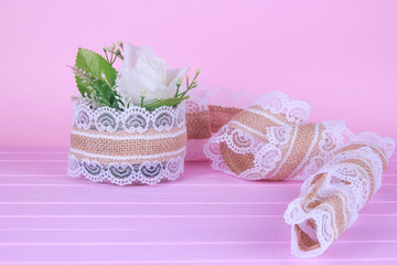 Small white gyp flower bouquet in silver tin can vase with burlap and lace party or wedding table centerpiece decoration closeup