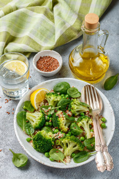 Quinoa with broccoli, spinach, peas, lemon and flax  seeds with olive oil. Detox warm or cold salad from green vegetables. Healthy meals, diet. Selective focus