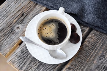 Delicious fresh tasty coffee on grey plaid