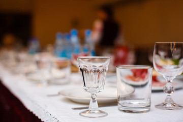 Beautiful glasses defocused on buffet table in restaurant and blurred background