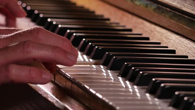 Playing the piano close up with backlight