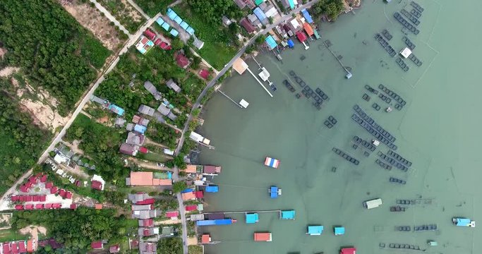 4k aerial movie of fishing farm and fisherman village on the shore of songkhla lake, thailanda