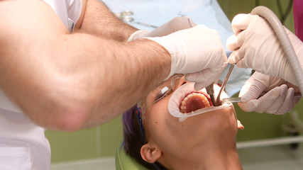 Dentist and assistant were bent over by the patient while performing therapeutic manipulation