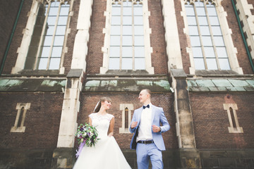 Gorgeous wedding couple walking in the old city of Lviv