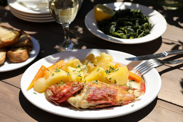 Cooked fresh red scorpionfish sarved with boiled potatoes in the greek tavern.