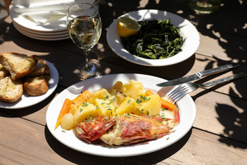 Cooked fresh red scorpionfish sarved with boiled potatoes in the greek tavern.